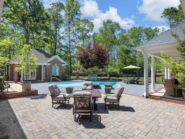 view of patio featuring a fenced in pool, an outdoor structure, an exterior structure, and fence