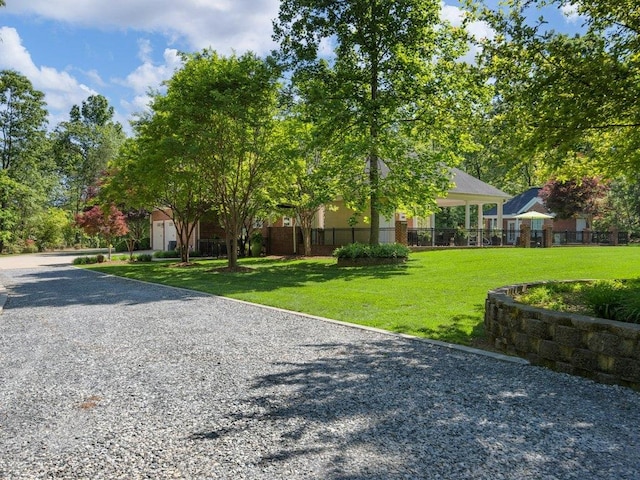 exterior space with fence and a front lawn