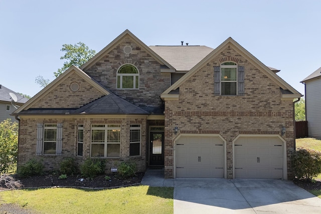 view of front of house with brick siding, a garage, a front lawn, and driveway