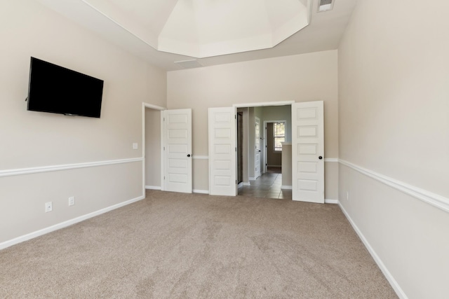 unfurnished bedroom with carpet floors, baseboards, and visible vents