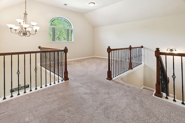 hallway with a chandelier, visible vents, an upstairs landing, carpet floors, and lofted ceiling