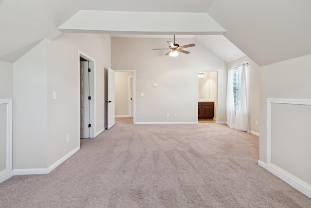 additional living space with light colored carpet, a ceiling fan, baseboards, and lofted ceiling