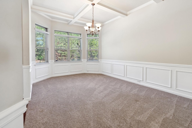 carpeted spare room featuring wainscoting, a decorative wall, beam ceiling, a chandelier, and coffered ceiling