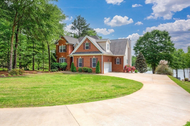 craftsman inspired home featuring brick siding, a garage, a front yard, a chimney, and driveway