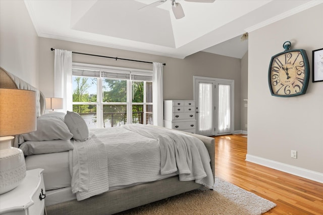 bedroom with crown molding, baseboards, ceiling fan, and light wood-style flooring