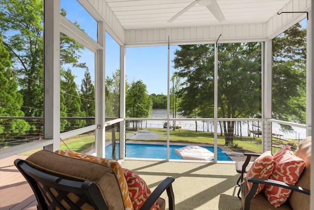 sunroom / solarium featuring a water view, a ceiling fan, and a wealth of natural light