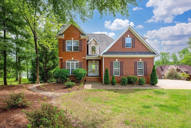 traditional-style home with brick siding and a front lawn