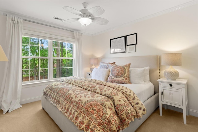 bedroom featuring visible vents, ornamental molding, baseboards, and light colored carpet