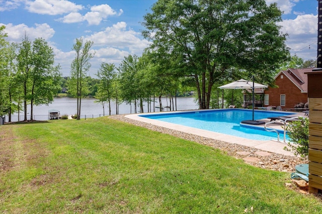 view of swimming pool featuring a fenced in pool, a water view, and a yard