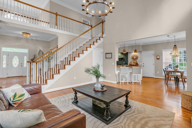 268 Antrim, Moore, SC 29369 - living area with a notable chandelier, ornamental molding, a healthy amount of sunlight, and a towering ceiling