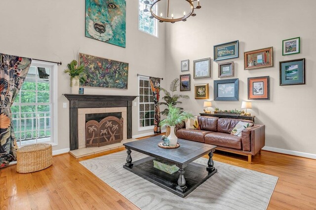 268 Antrim, Moore, SC 29369 - living room featuring a healthy amount of sunlight, baseboards, wood finished floors, and a chandelier