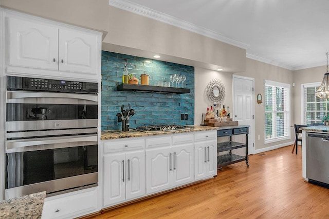 268 Antrim, Moore, SC 29369 - kitchen with light stone counters, light wood-style floors, ornamental molding, stainless steel appliances, and white cabinetry