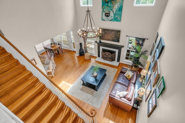 268 Antrim, Moore, SC 29369 - living room featuring wood finished floors, a chandelier, a high ceiling, and a healthy amount of sunlight