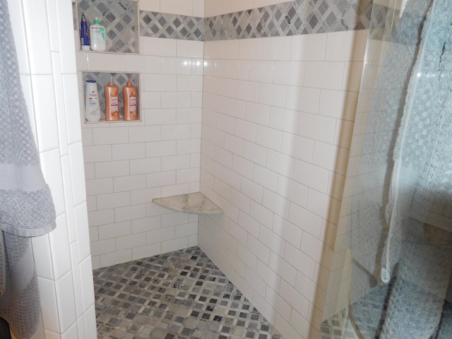 bathroom with a tile shower