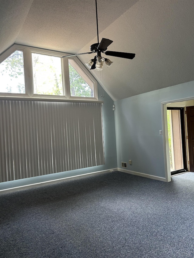 interior space featuring visible vents, a ceiling fan, a textured ceiling, and lofted ceiling