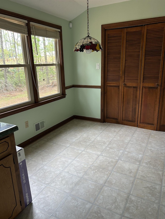 unfurnished dining area featuring visible vents and baseboards