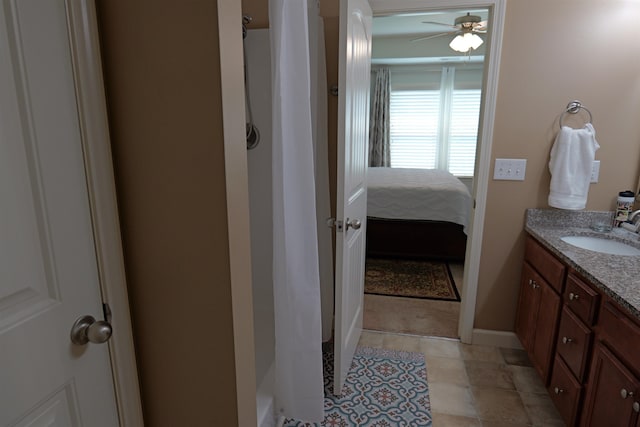 bathroom featuring a shower with curtain, ceiling fan, and vanity