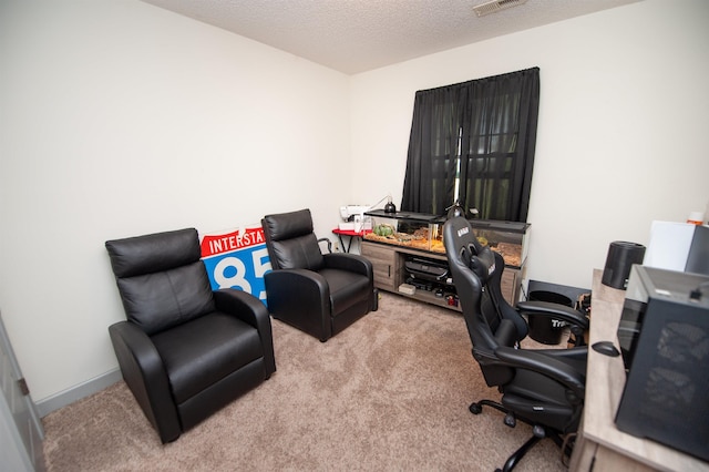 carpeted home office with a textured ceiling
