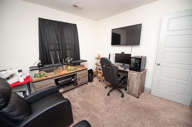 office space with visible vents, a textured ceiling, and light carpet