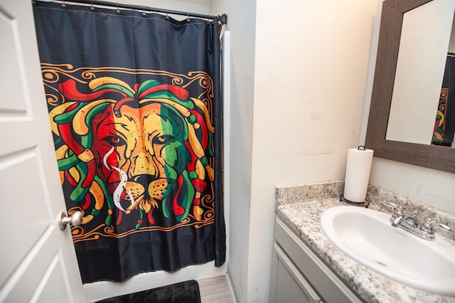 bathroom featuring vanity and curtained shower