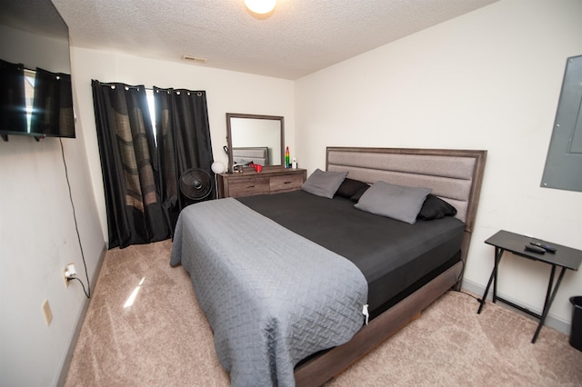 carpeted bedroom with a textured ceiling and visible vents
