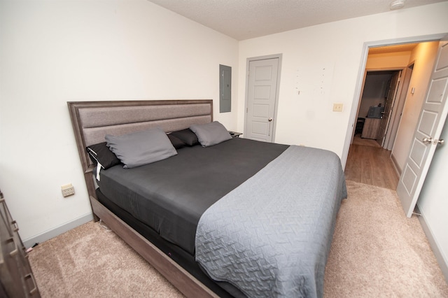 bedroom featuring baseboards and electric panel