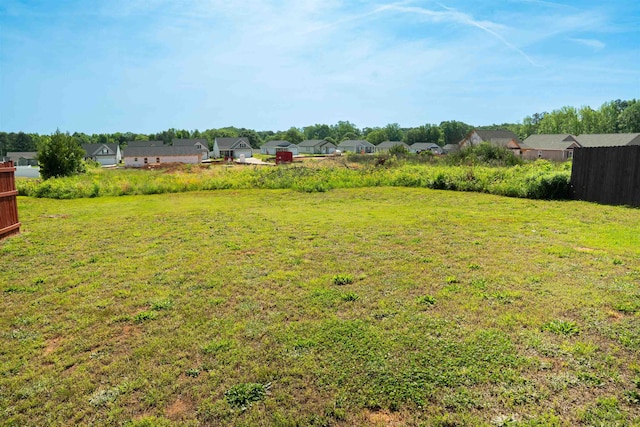 view of yard with fence and a residential view