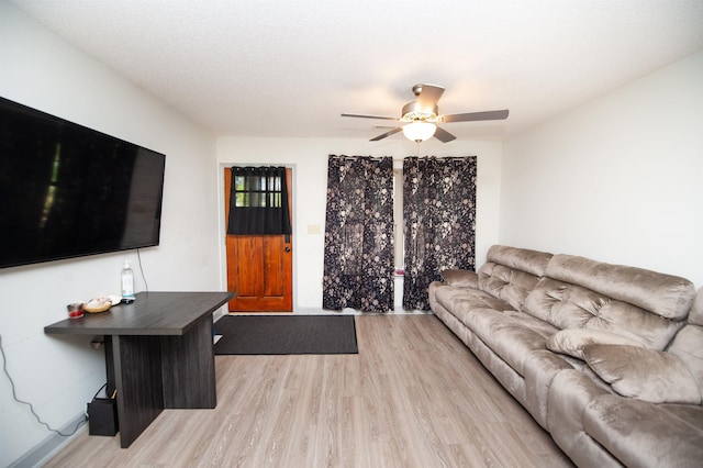living area featuring a ceiling fan and light wood-style flooring