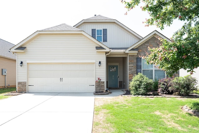 view of front of house with a garage, a front yard, stone siding, board and batten siding, and concrete driveway