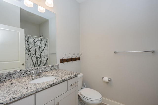 bathroom featuring vanity, baseboards, toilet, and a shower with shower curtain