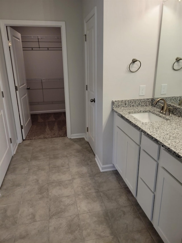 bathroom featuring vanity and a spacious closet