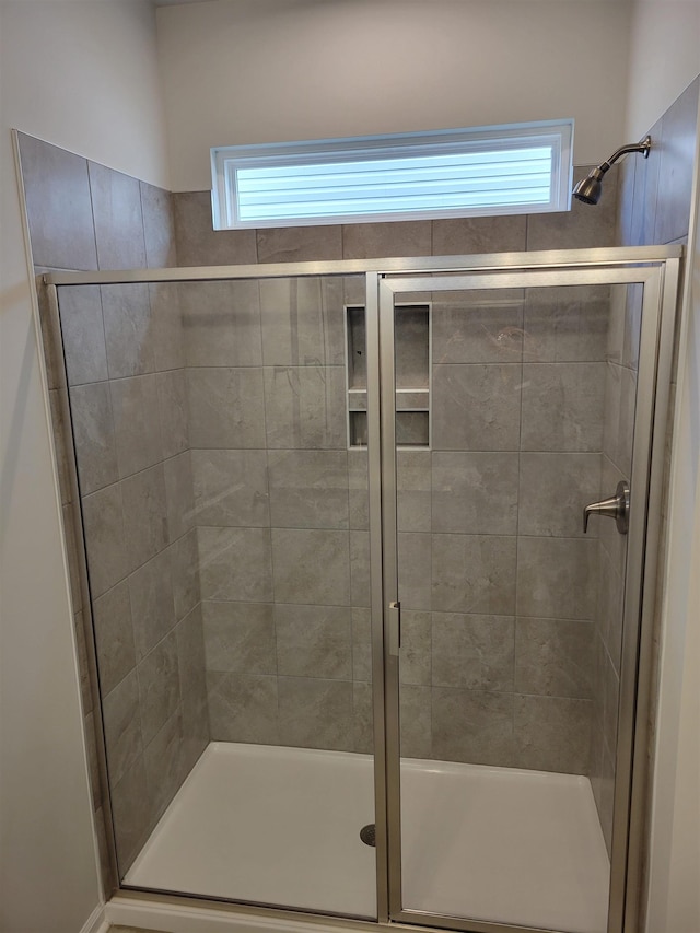 bathroom with a shower stall