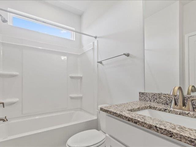 full bathroom featuring vanity, toilet, and  shower combination