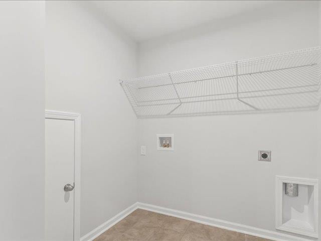 clothes washing area with hookup for an electric dryer, laundry area, baseboards, and washer hookup