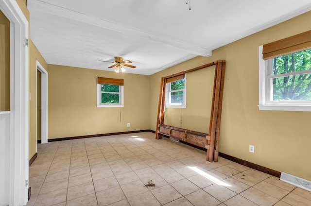 spare room with light tile patterned floors, baseboards, ceiling fan, and visible vents