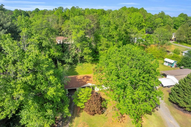 drone / aerial view featuring a wooded view