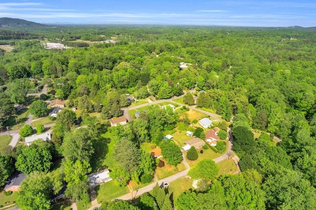 drone / aerial view featuring a wooded view