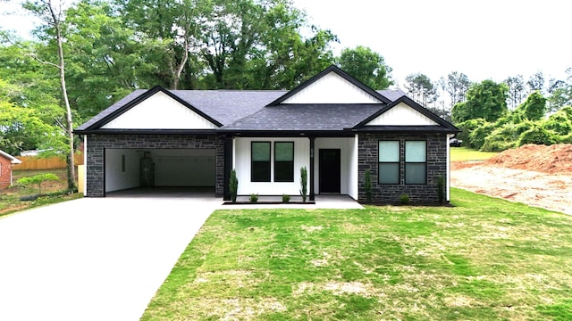 view of front facade with driveway, roof with shingles, brick siding, a front lawn, and an attached garage