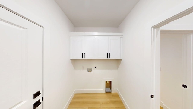 laundry area with hookup for an electric dryer, cabinet space, baseboards, hookup for a washing machine, and light wood-style flooring