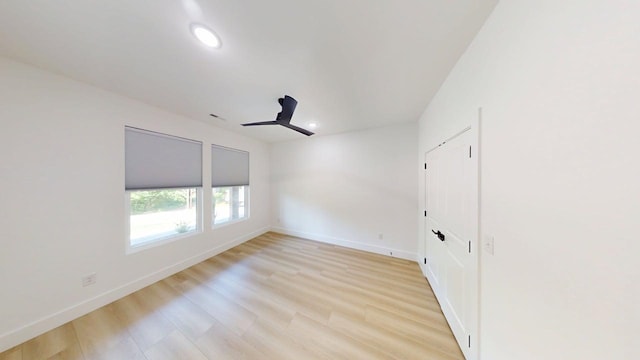 spare room with recessed lighting, baseboards, a ceiling fan, and light wood-type flooring