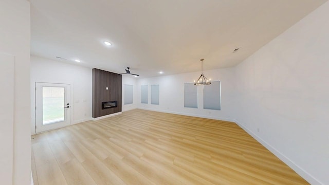 unfurnished living room with recessed lighting, baseboards, a large fireplace, and light wood-type flooring