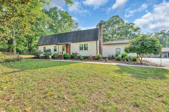 view of front of property featuring a front yard and a chimney