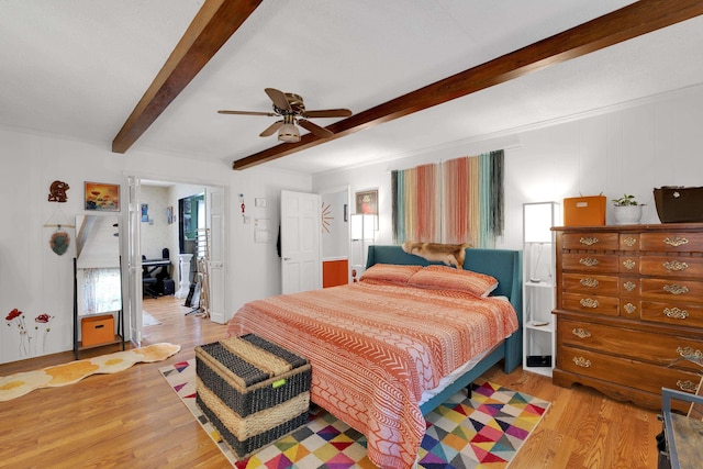 bedroom featuring light wood-style floors, a ceiling fan, and beamed ceiling