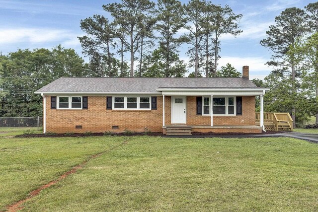 ranch-style house with brick siding, crawl space, a chimney, and a front lawn