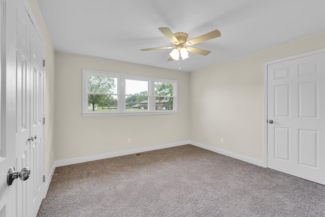 unfurnished bedroom with carpet floors, baseboards, and a closet