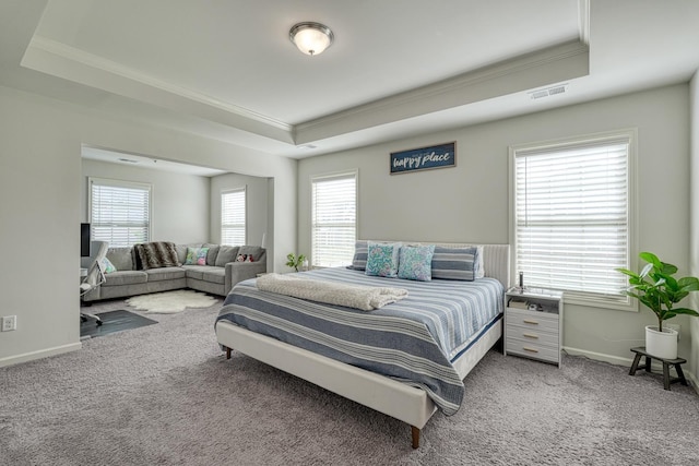 bedroom with crown molding, a raised ceiling, carpet, and visible vents