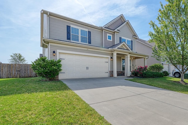 view of front of house with an attached garage, fence, driveway, and a front yard