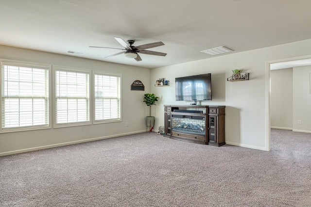 unfurnished living room featuring a ceiling fan, baseboards, visible vents, and carpet