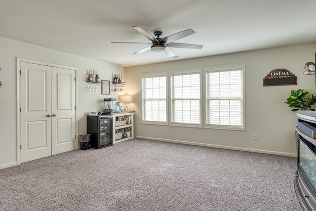 carpeted living room featuring baseboards, ceiling fan, and visible vents