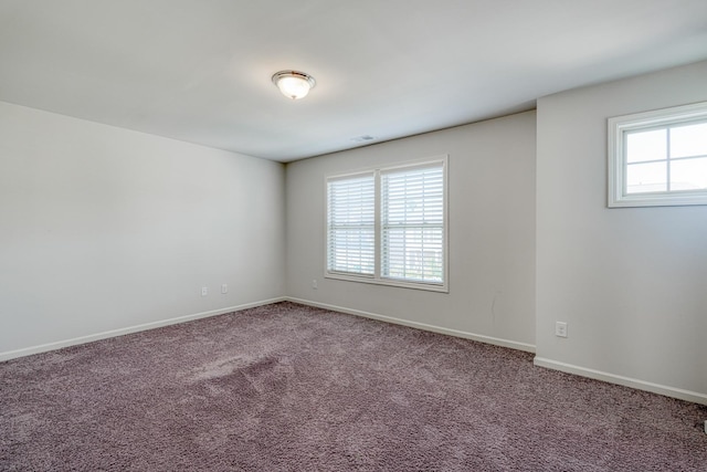 carpeted empty room with baseboards and visible vents